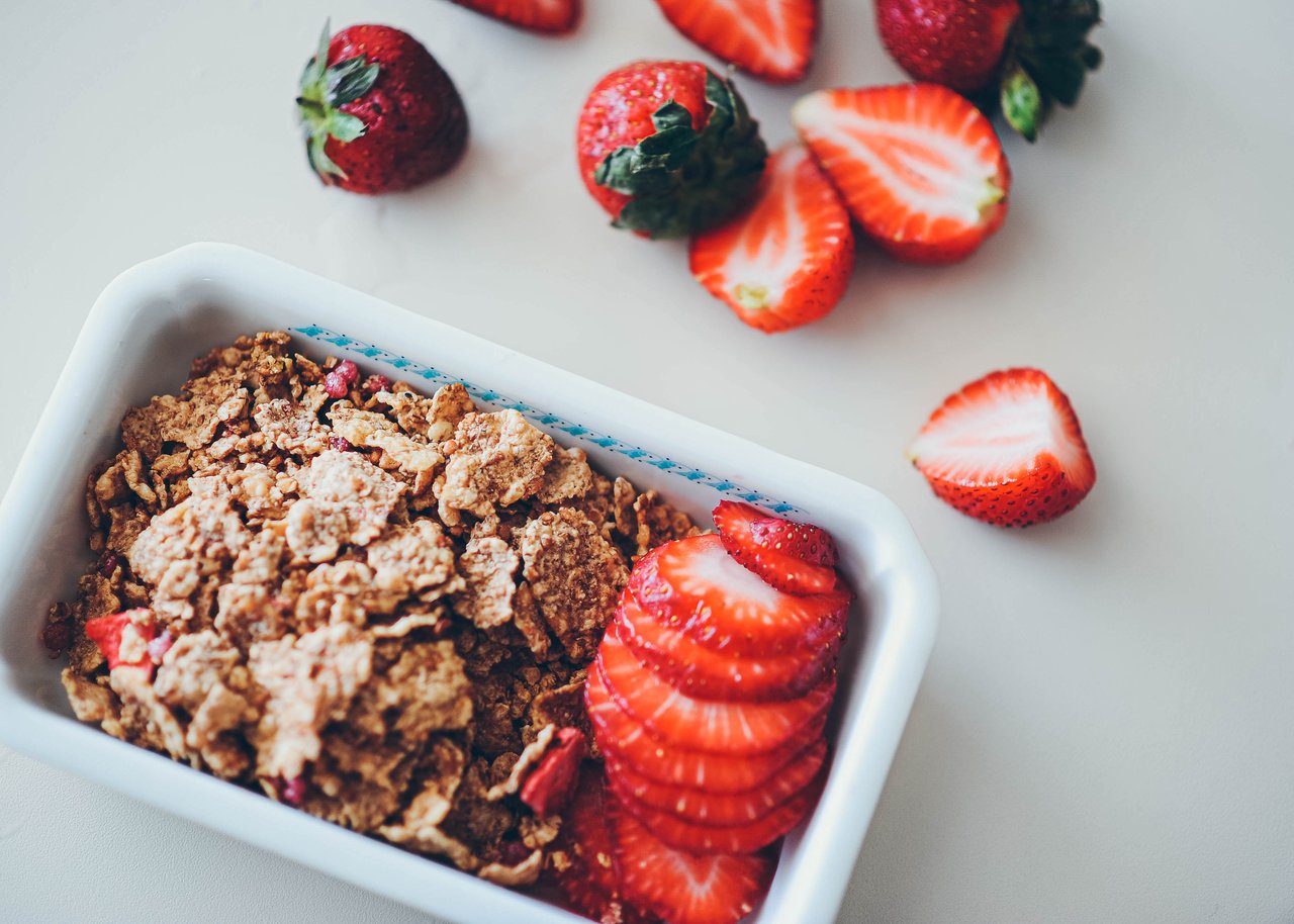 Services Close-up view of strawberries and cereal for a nutritious breakfast option.